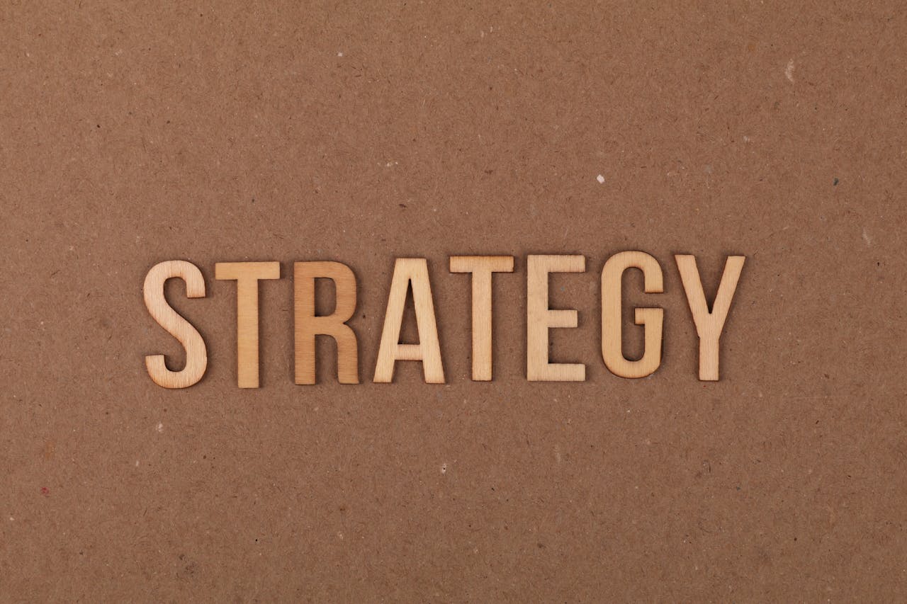 Wooden letters spelling Strategy on a cardboard background, perfect for business concepts.